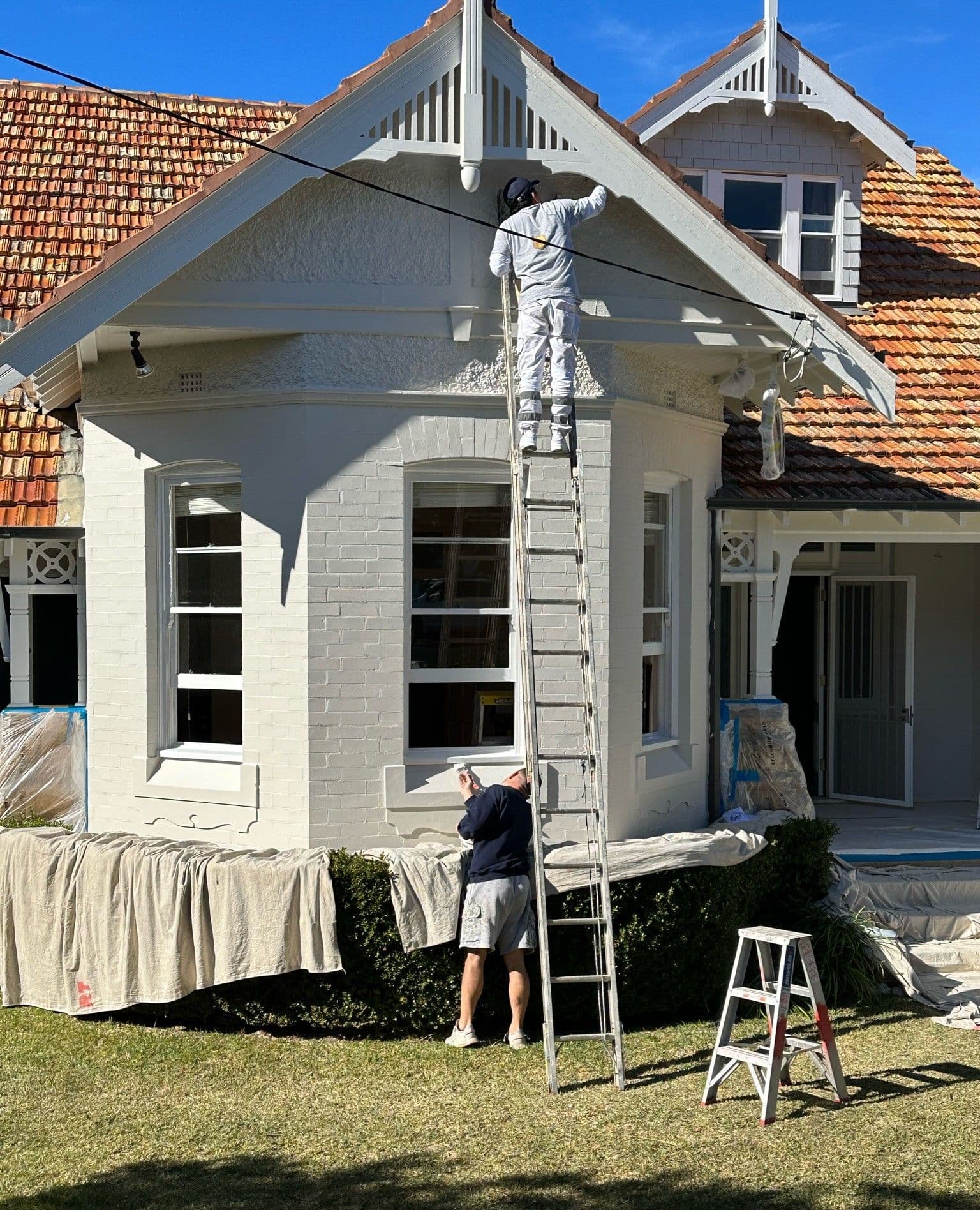 Roberts Trading painter preparing a home exterior
